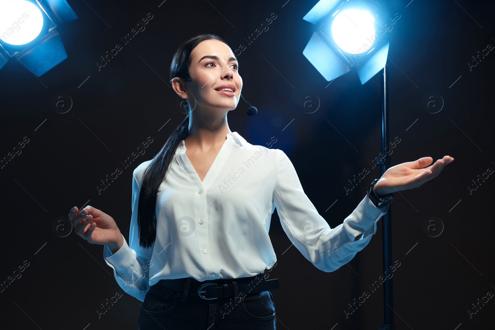 Photo of Motivational speaker with headset performing on stage