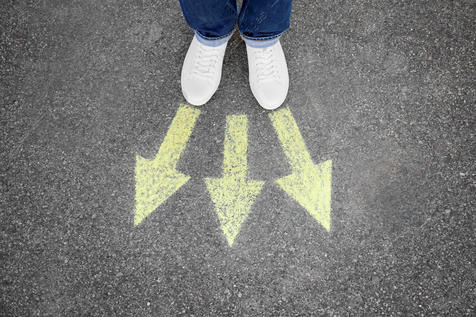 Photo of Woman standing on road near arrows marking, closeup