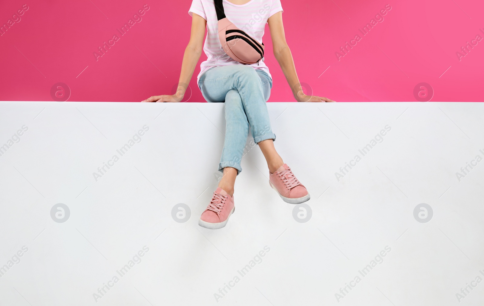 Photo of Woman wearing stylish shoes on color background, closeup