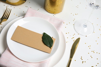 Elegant festive table setting with blank card on white background