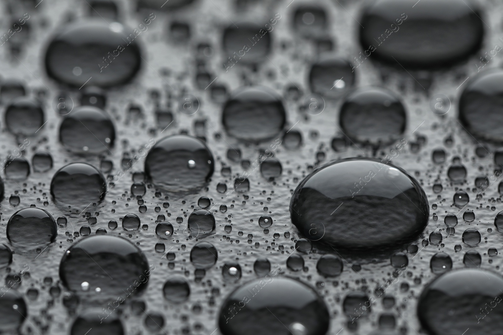 Photo of Water drops on grey background, closeup view