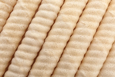 Delicious wafer rolls as background, top view. Sweet food