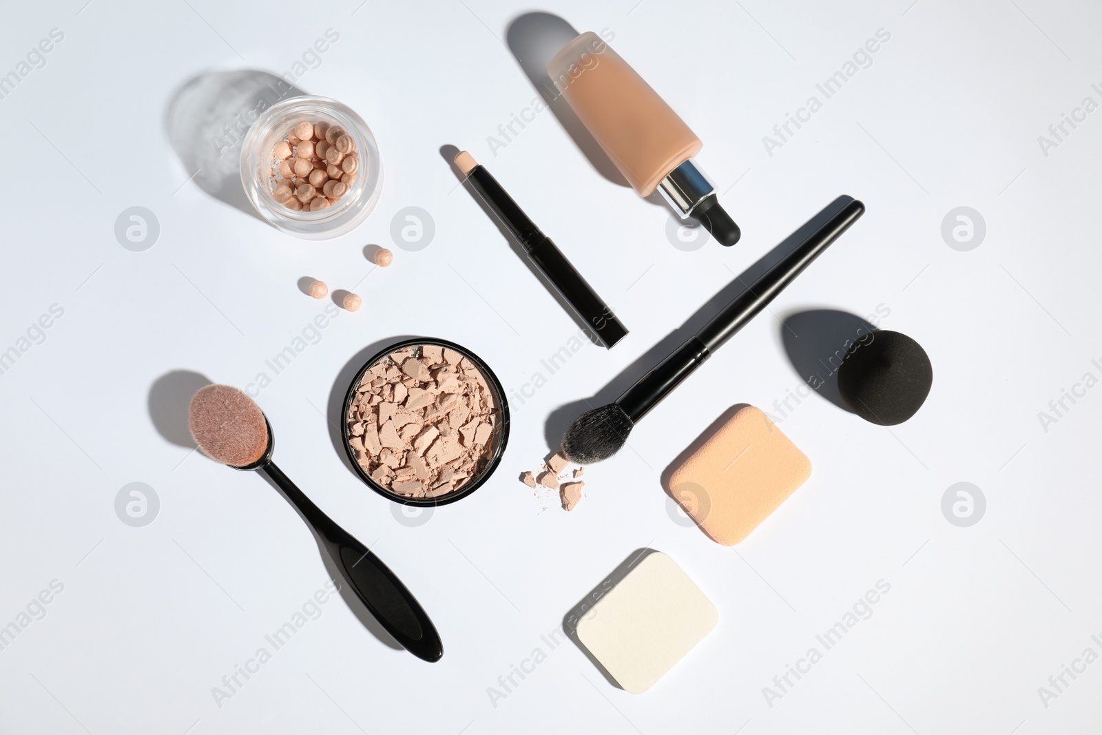 Photo of Flat lay composition with skin foundation and powder on white background