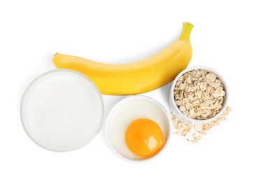 Photo of Tasty oatmeal pancakes and ingredients on white background, top view