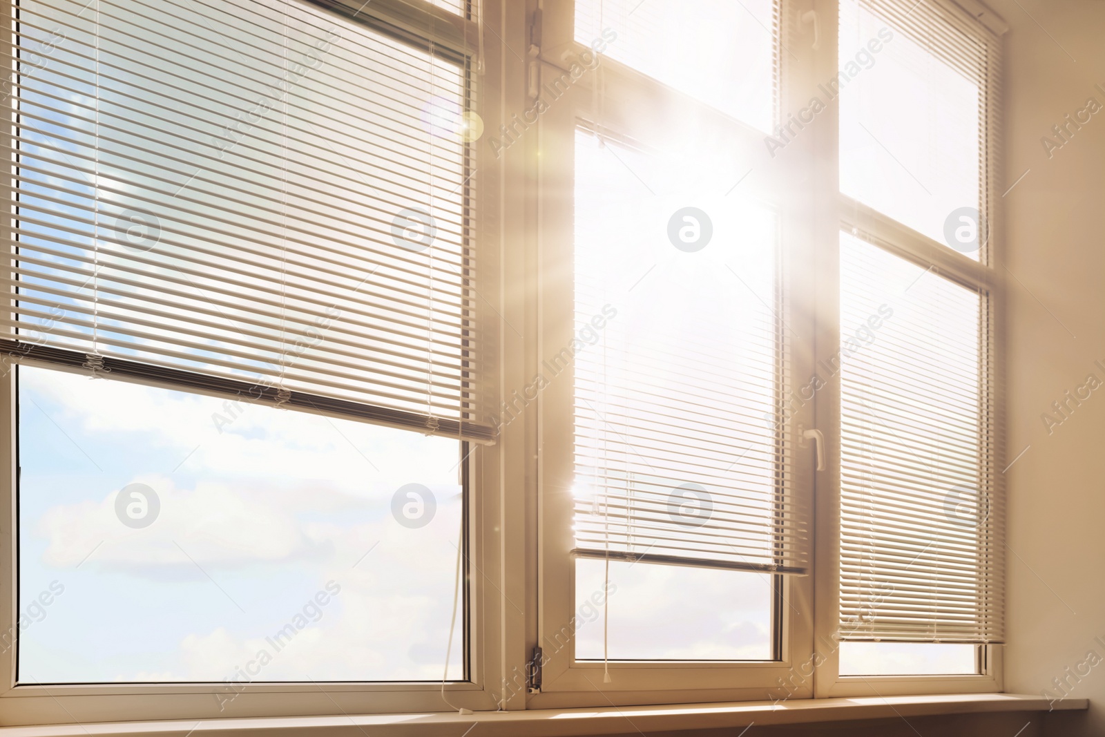 Image of Stylish window with horizontal blinds in room