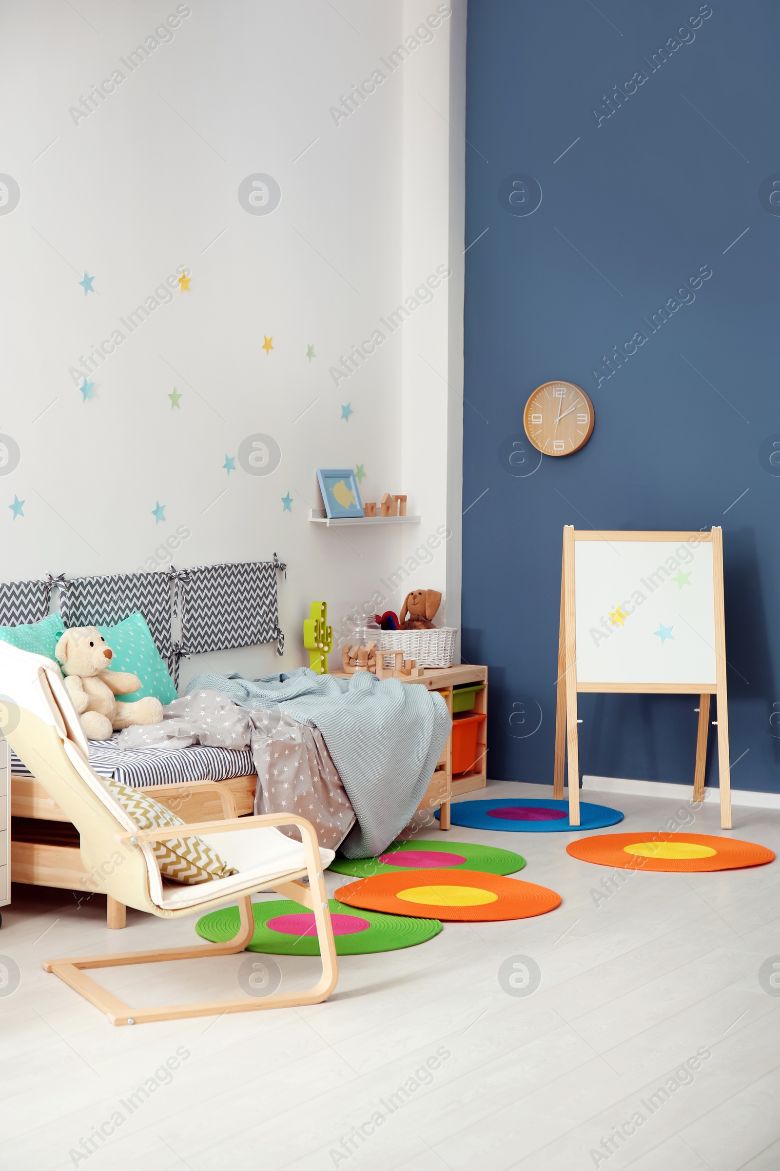 Photo of Modern child room interior with comfortable bed and armchair