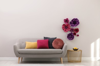 Photo of Stylish living room interior with floral decor and comfortable sofa, space for text