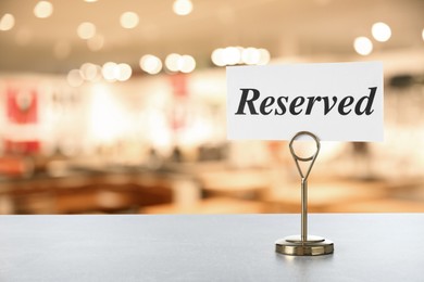 Image of Sign Reserved on white table in restaurant, space for text
