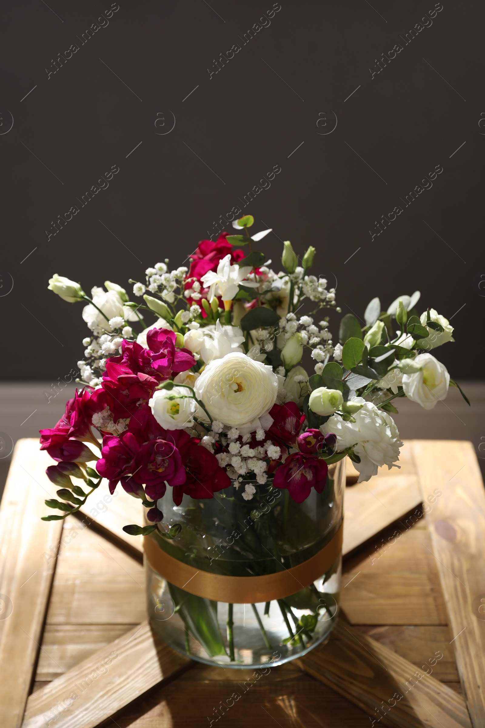 Photo of Beautiful sunlit bouquet with spring freesia flowers indoors