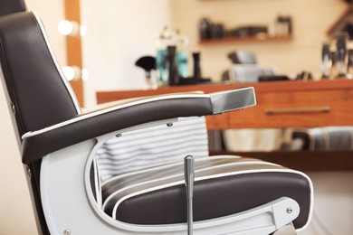 Photo of Closeup viewprofessional barber chair in hairdressing salon