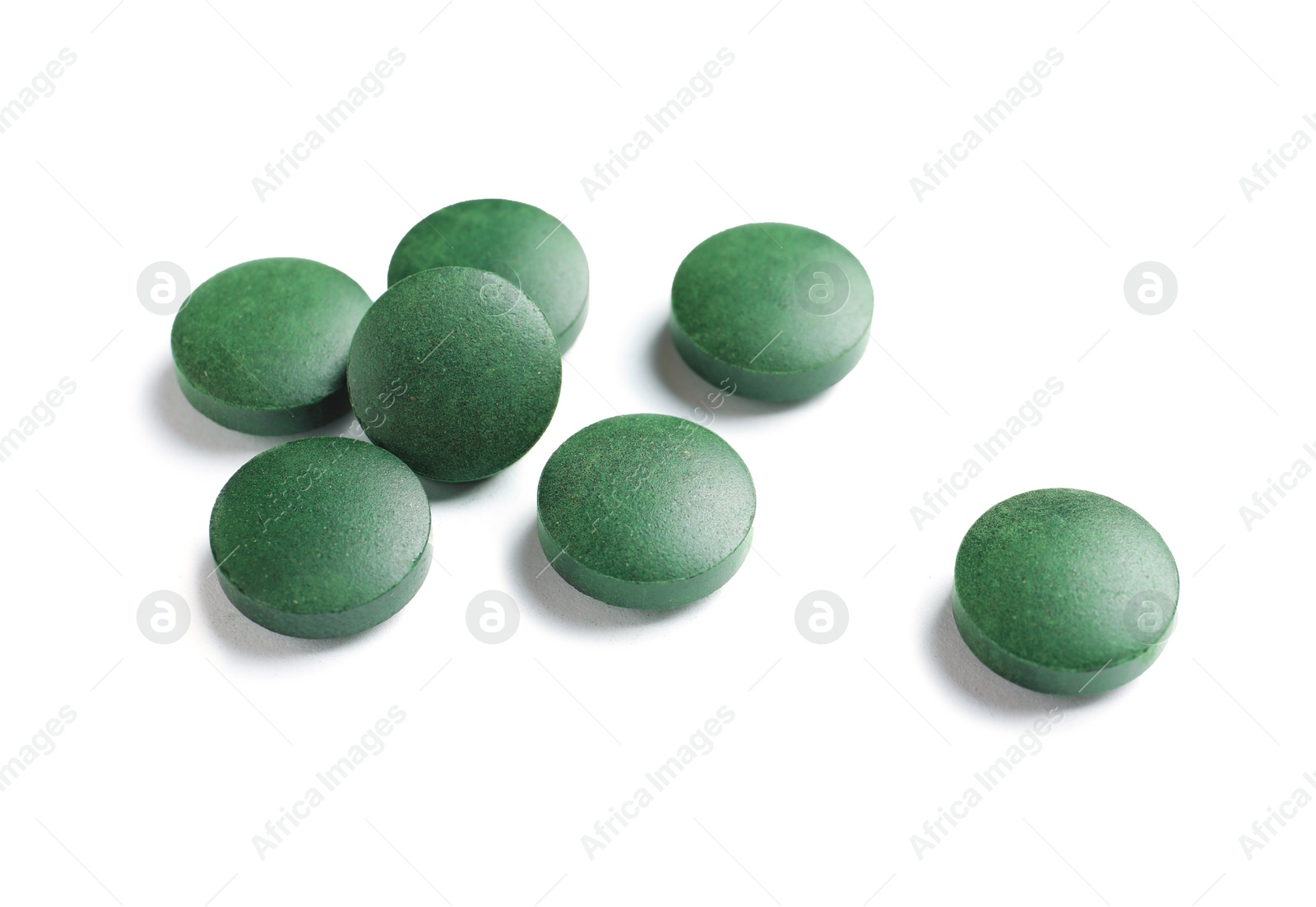 Photo of Spirulina tablets on white background. Healthy lifestyle