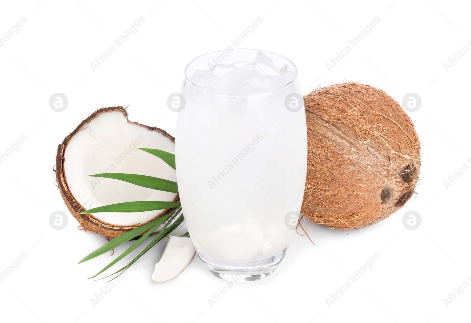 Photo of Glass of coconut water, ice cubes, leaf and nuts isolated on white