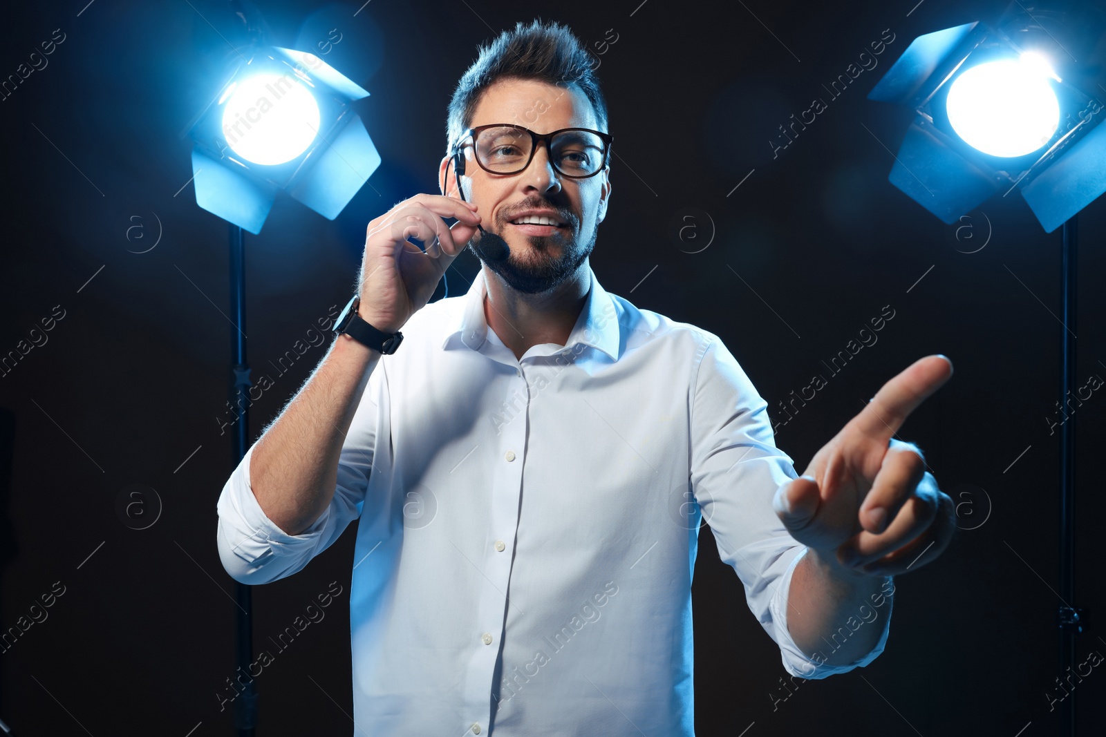 Photo of Motivational speaker with headset performing on stage