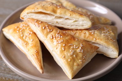 Delicious fresh puff pastries on table, closeup