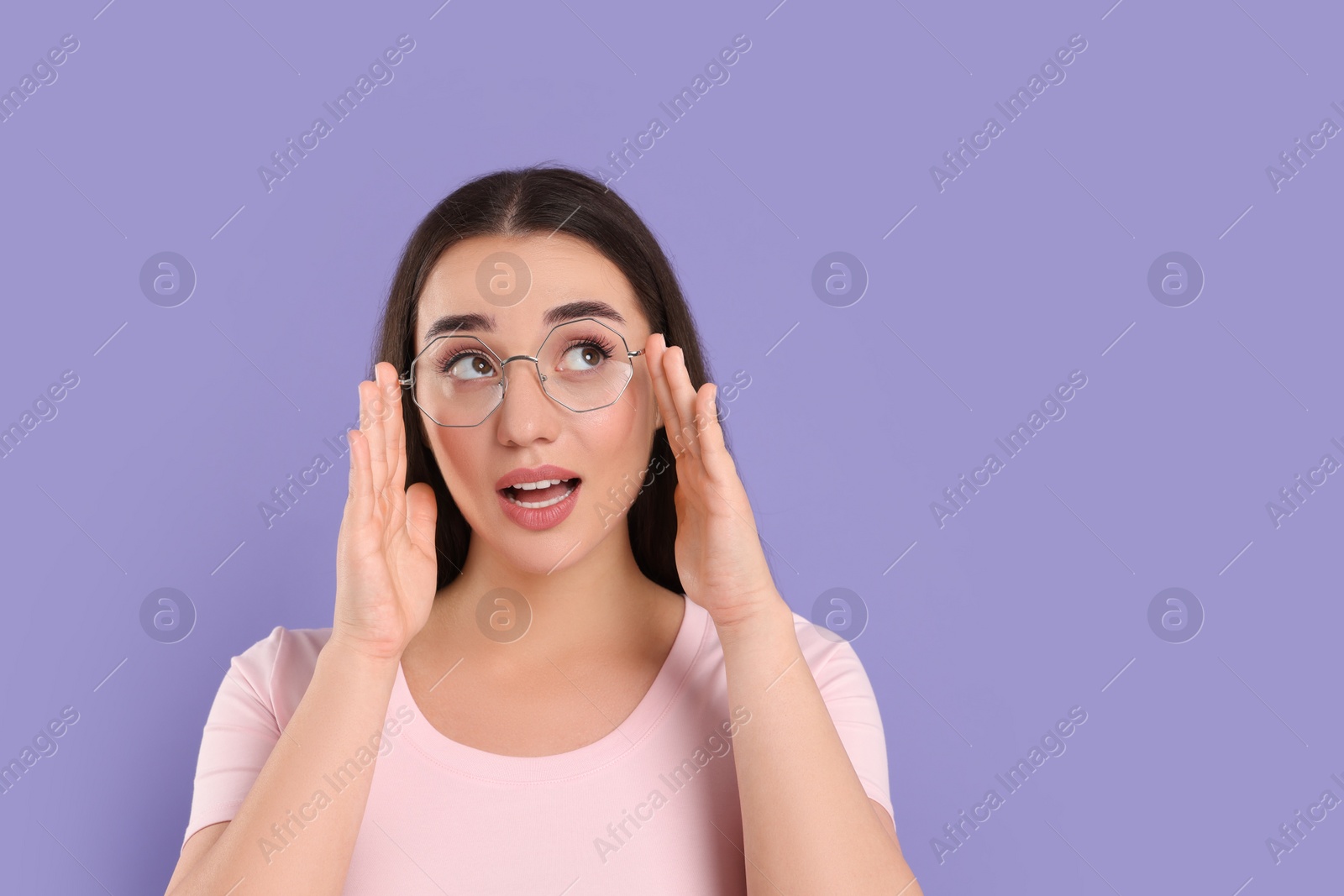 Photo of Beautiful woman wearing glasses on violet background, space for text
