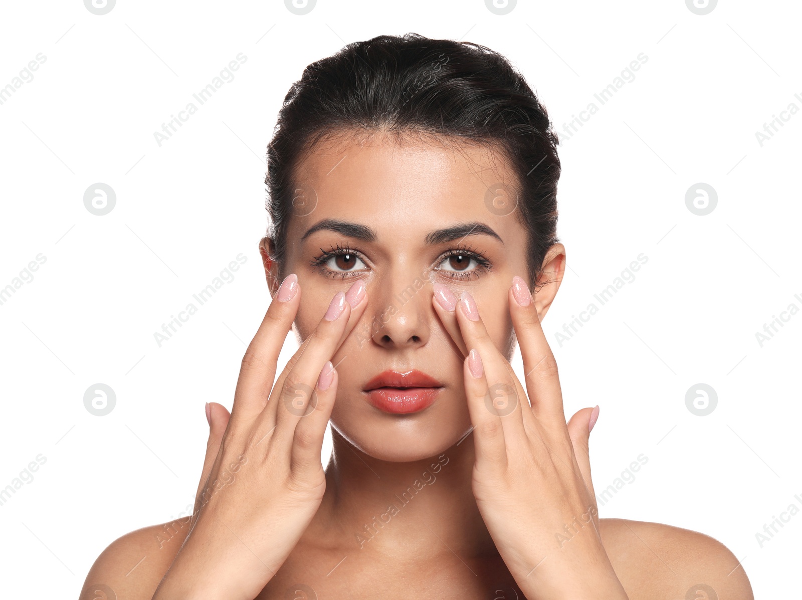 Photo of Woman applying cream under eyes on white background. Skin care