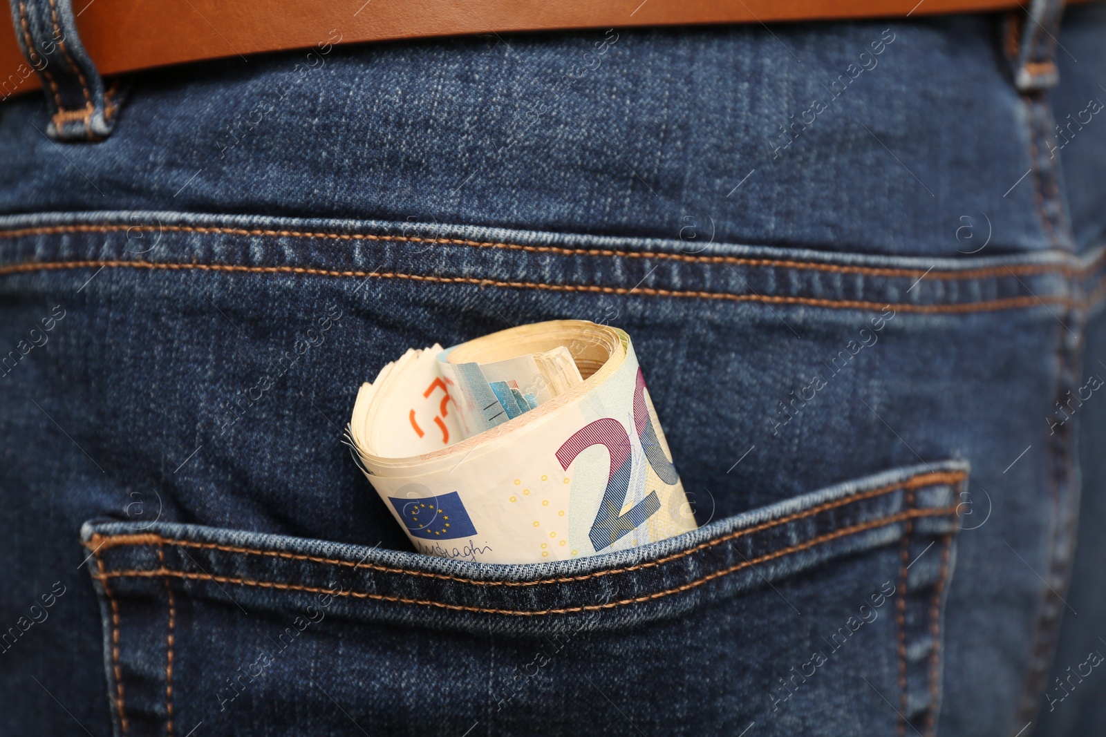 Photo of Euro banknotes in pocket of jeans, closeup. Spending money