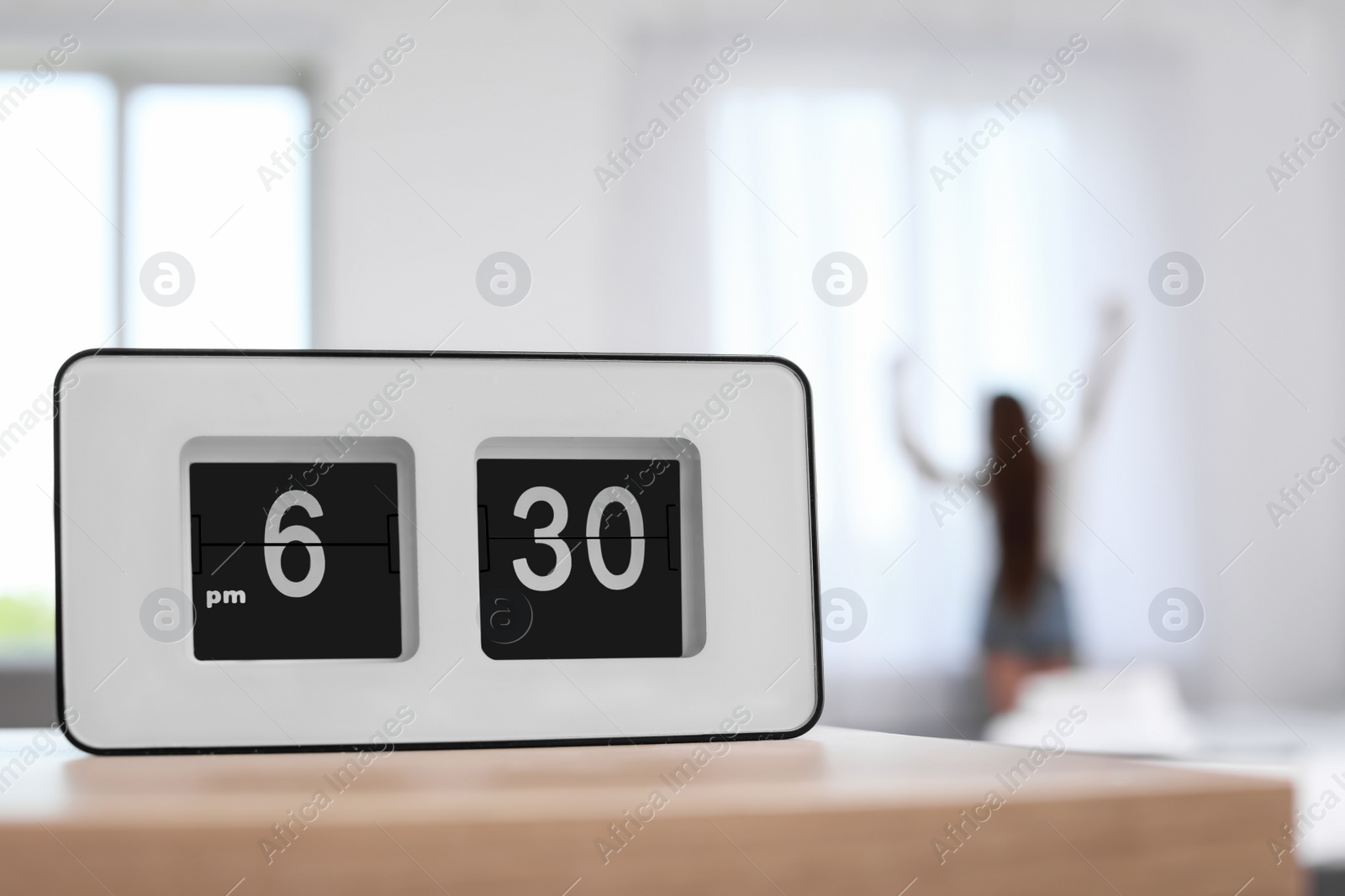 Photo of Digital alarm clock on table. Time to wake up