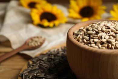 Photo of Raw sunflower seeds on table, closeup. Space for text
