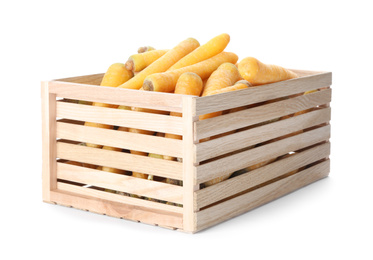 Photo of Raw yellow carrots in wooden crate isolated on white