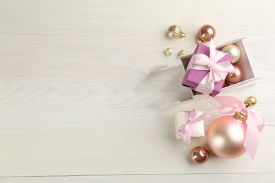 Photo of Beautiful Christmas composition with miniature sleigh on white wooden table, flat lay. Space for text