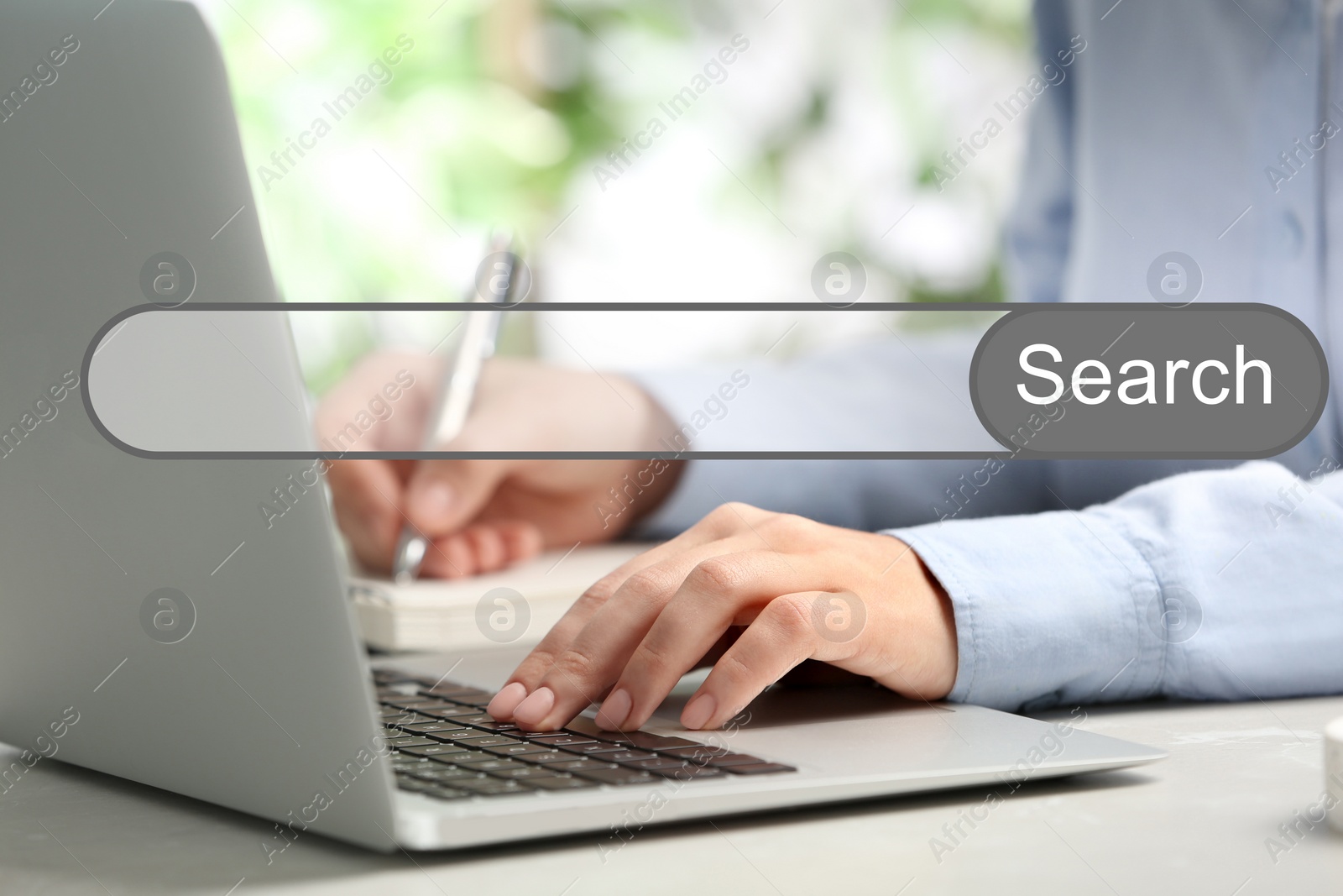 Image of Search bar of internet browser and woman working with laptop at table indoors, closeup