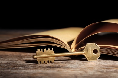 Photo of Old vintage key with book on wooden table