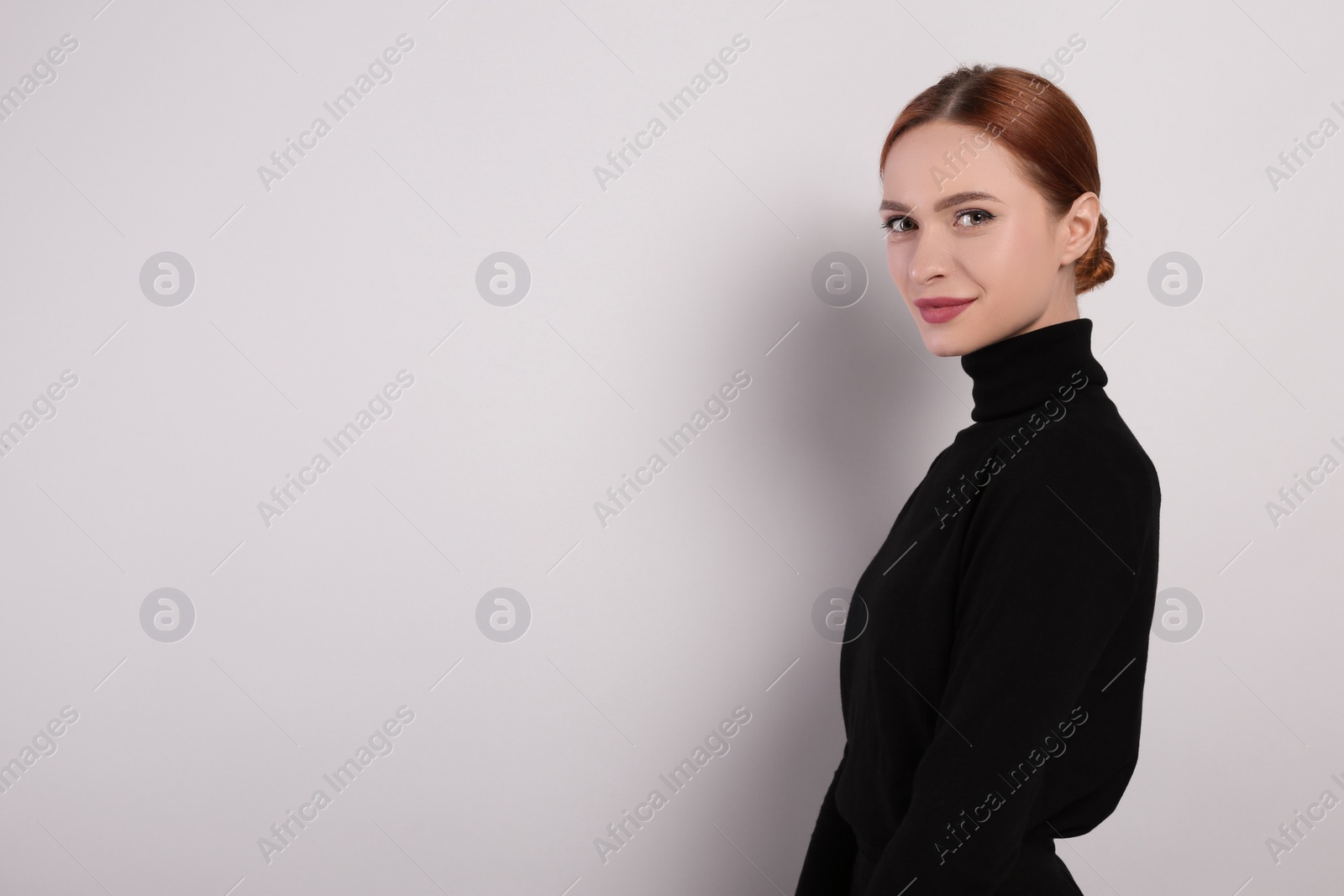 Photo of Portrait of beautiful young woman on light gray background, space for text