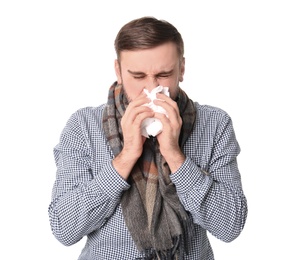 Photo of Young man with cold sneezing on white background