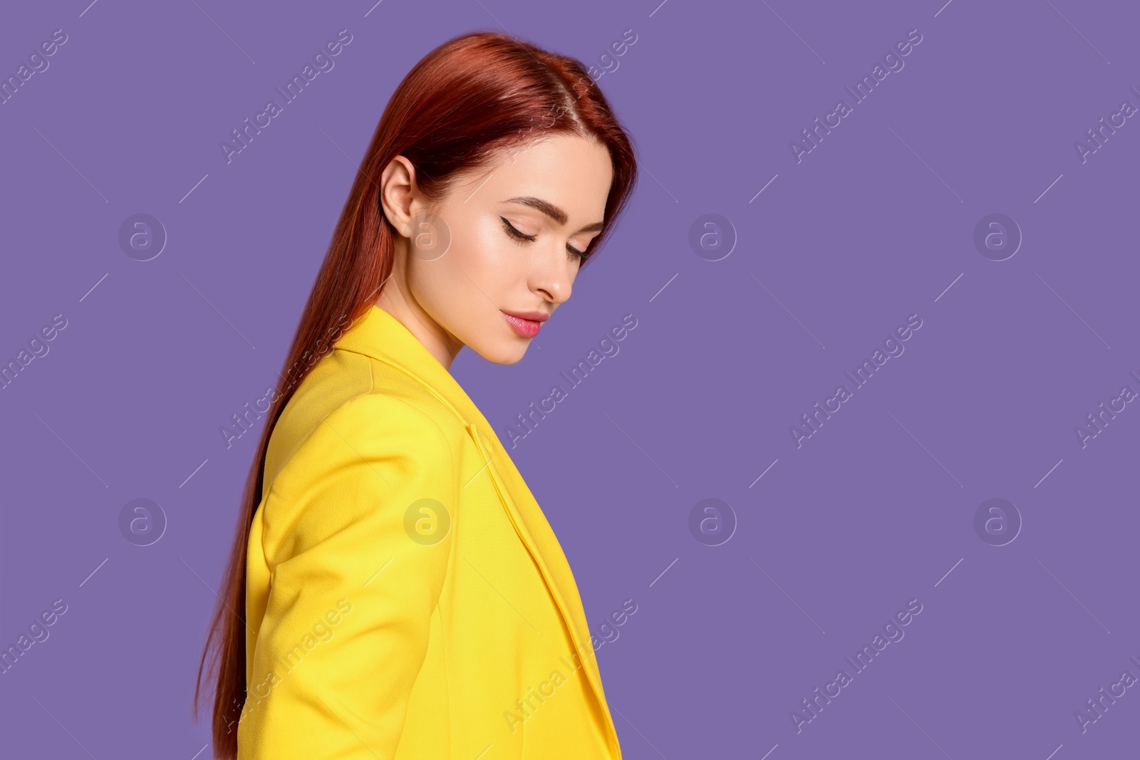 Photo of Stylish woman with red dyed hair on purple background, space for text