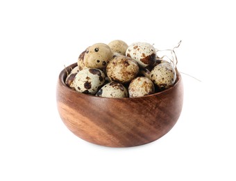 Wooden bowl with quail eggs and straw isolated on white