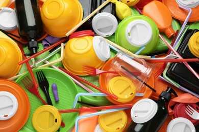 Photo of Different colorful plastic items as background, closeup