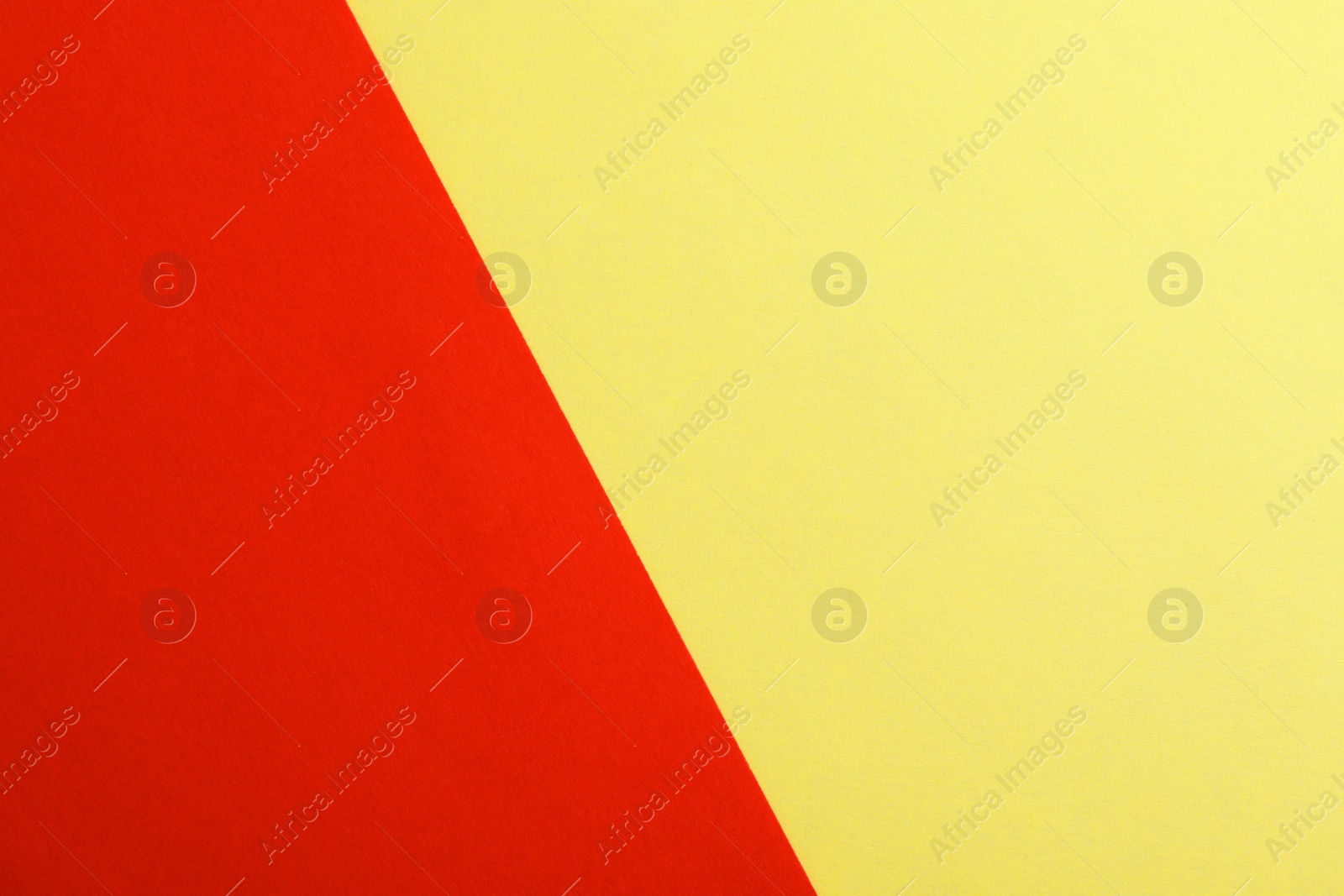 Photo of Yellow and red paper sheets as colorful background, top view