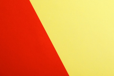 Photo of Yellow and red paper sheets as colorful background, top view