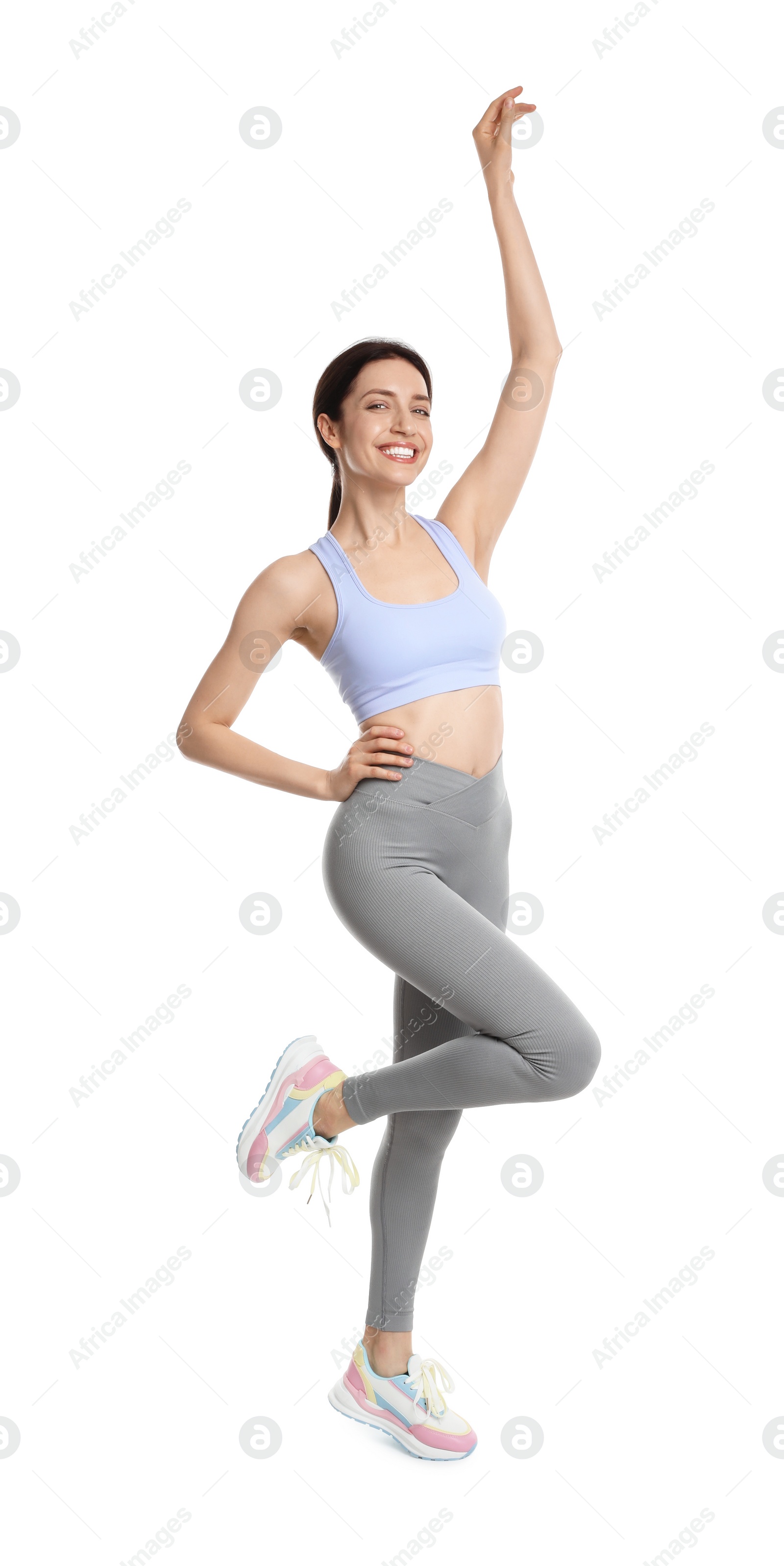 Photo of Happy young woman with slim body posing on white background