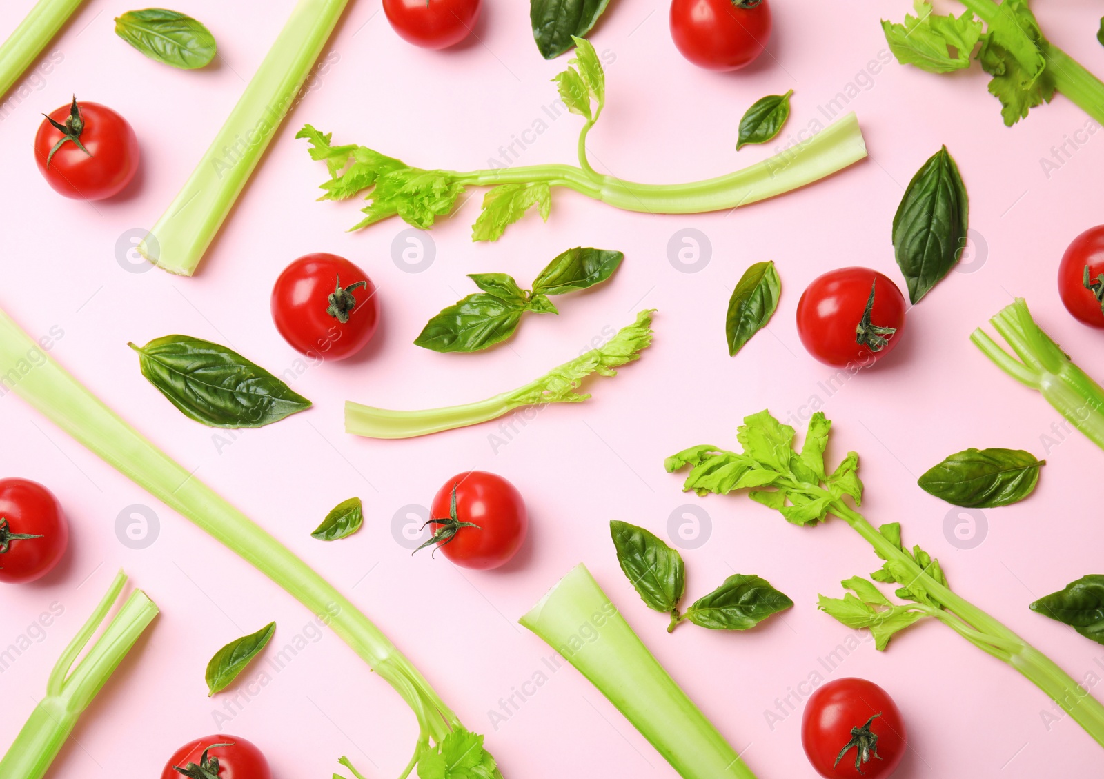 Photo of Flat lay composition with fresh ingredients for salad on pink background