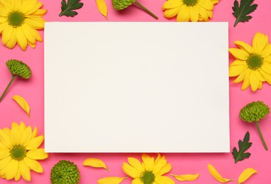 Beautiful chrysanthemums and blank card on pink background, flat lay. Space for text