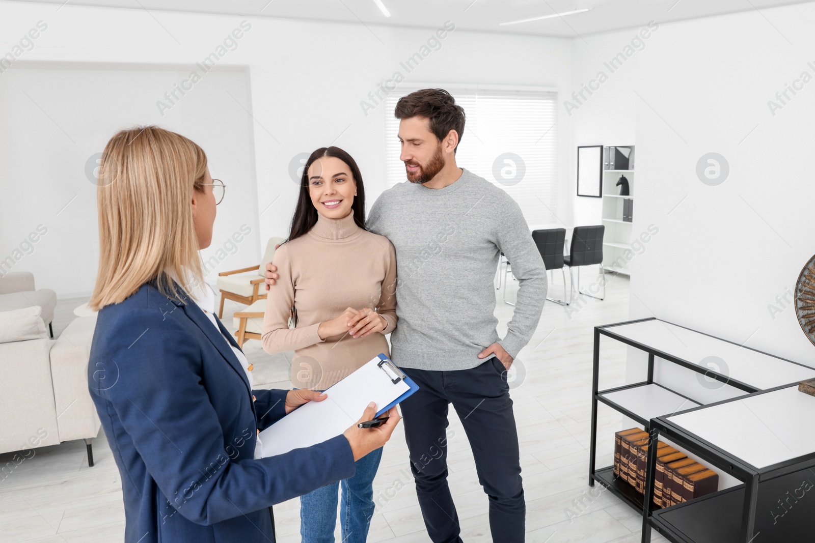 Photo of Real estate agent showing new apartment to couple