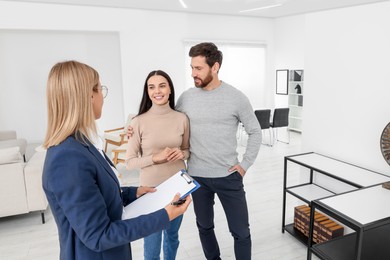 Photo of Real estate agent showing new apartment to couple