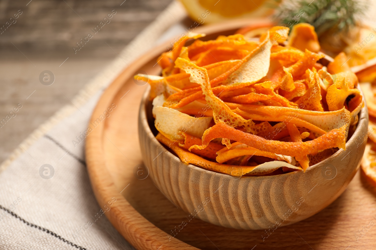 Photo of Dry orange peels on wooden table, closeup