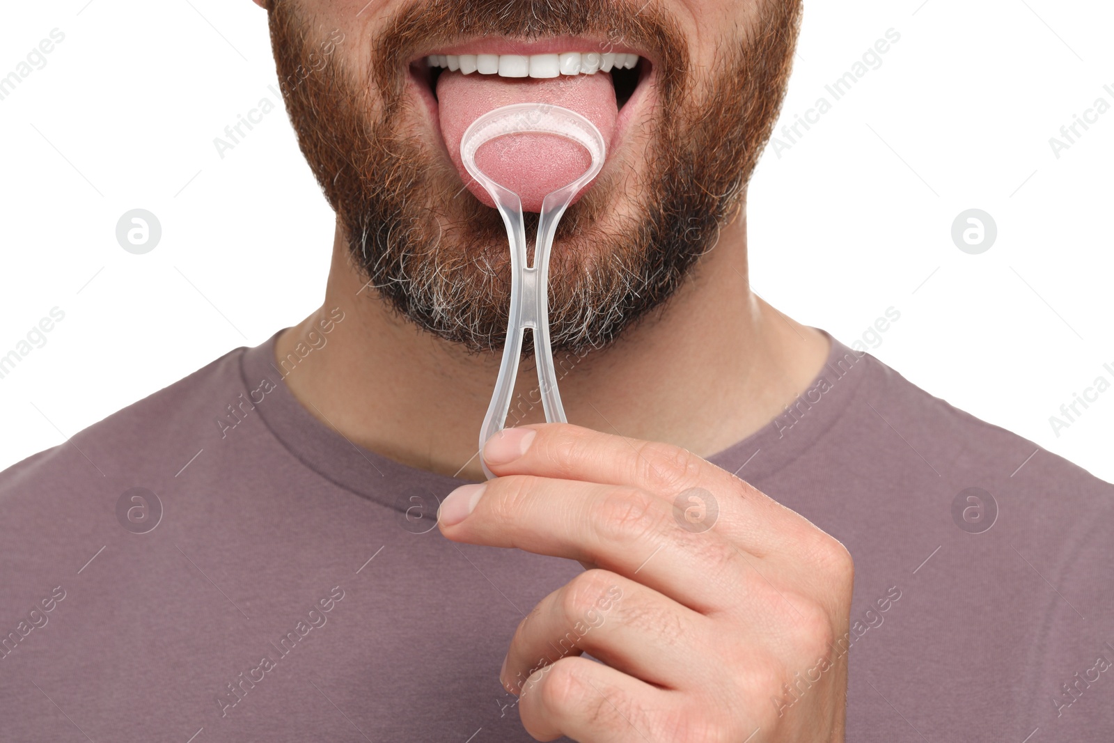 Photo of Man brushing his tongue with cleaner on white background, closeup