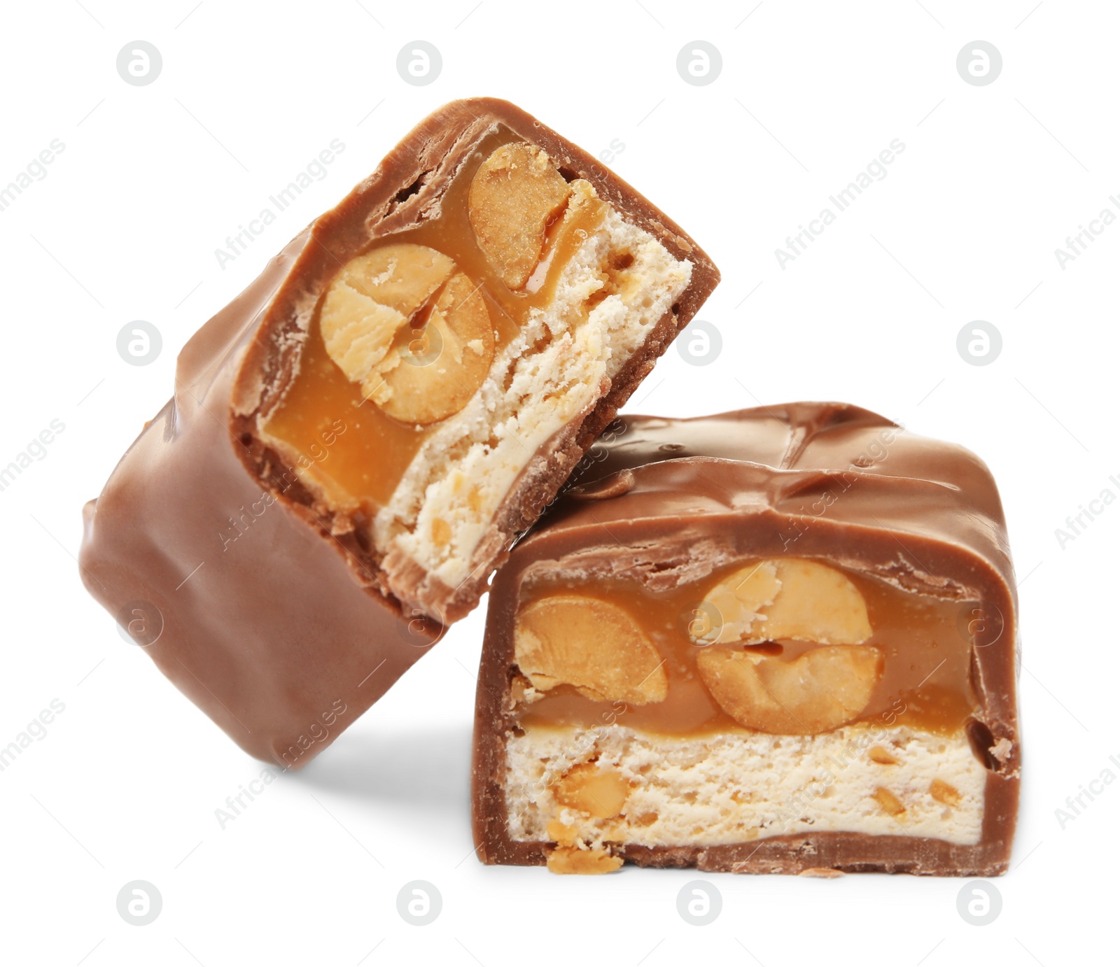 Photo of Cut chocolate bar with caramel, nuts and nougat isolated on white