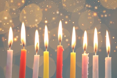 Image of Hanukkah celebration. Burning candles against blurred lights, closeup