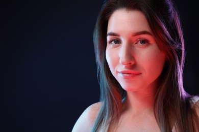 Portrait of beautiful young woman on color background, space for text