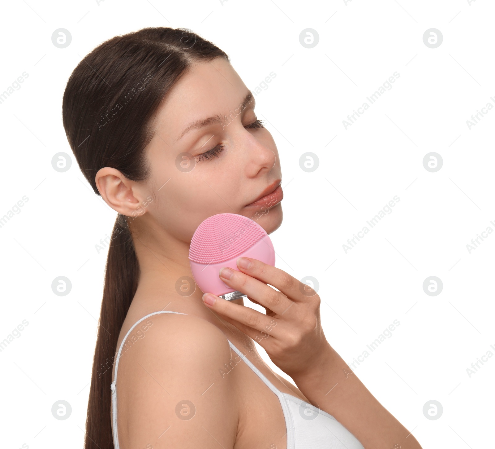 Photo of Washing face. Young woman with cleansing brush on white background