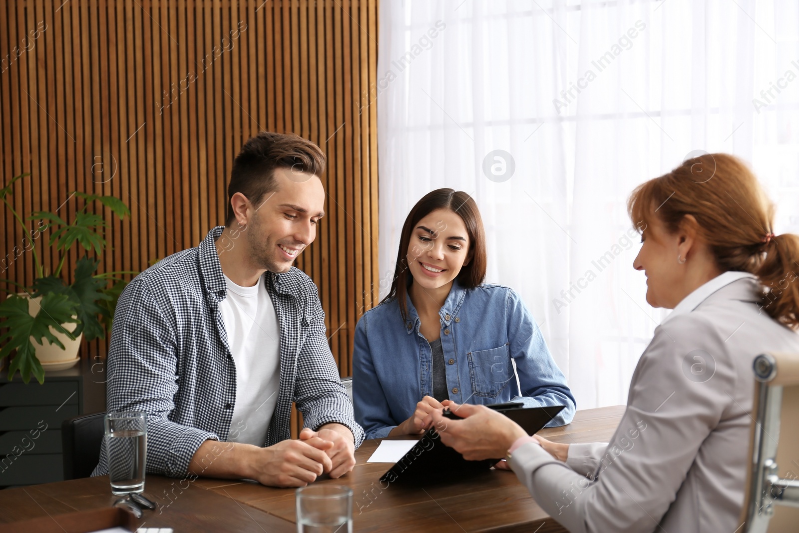 Photo of Lawyer having meeting with young couple in office