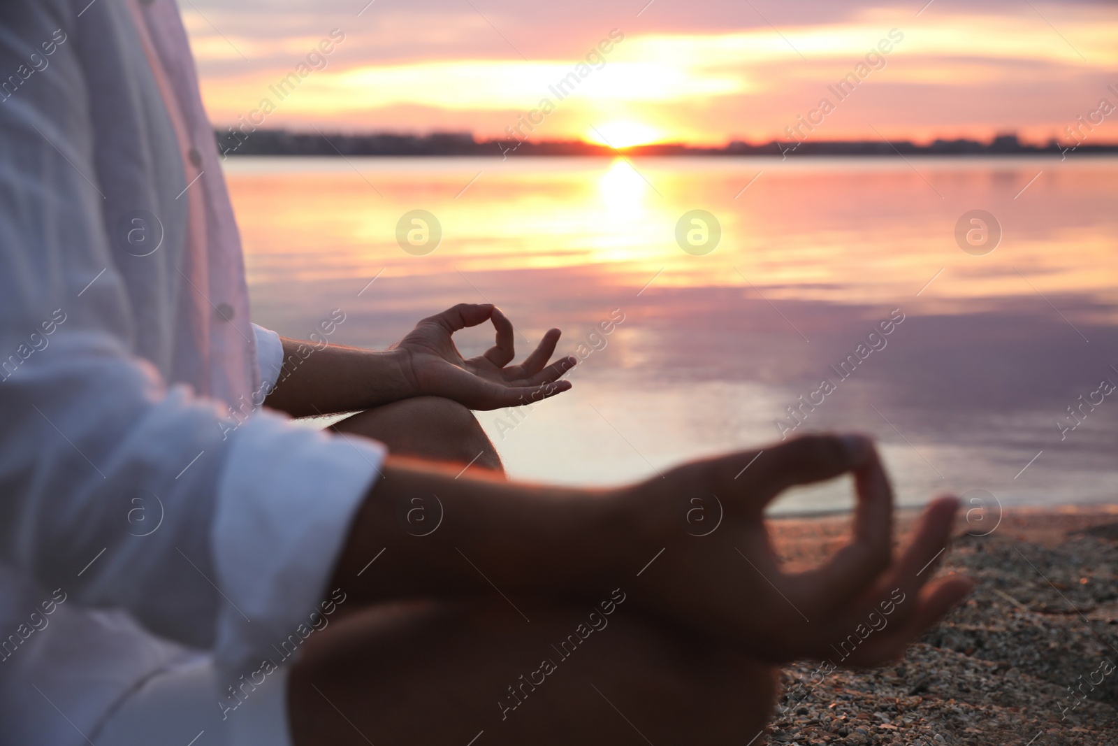 Photo of Man near river at sunset, closeup. Nature healing power