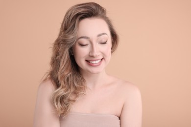 Photo of Portrait of smiling woman on beige background