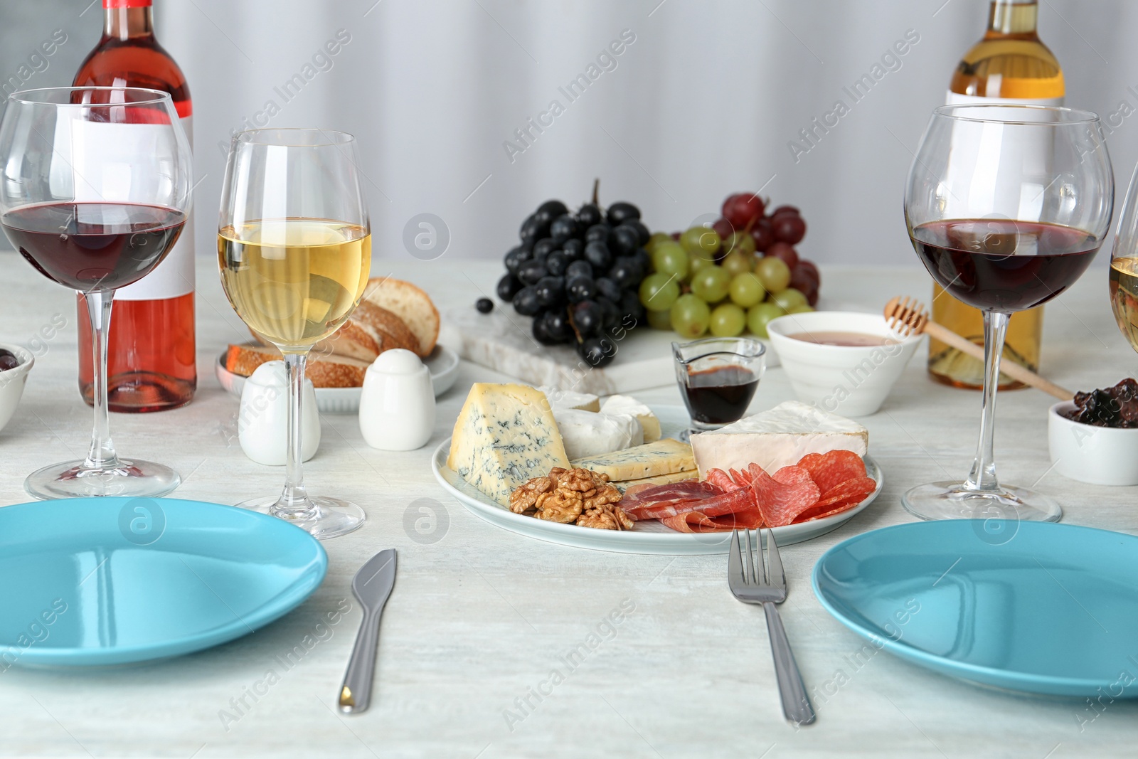 Photo of Wine and snacks served for dinner on table at home