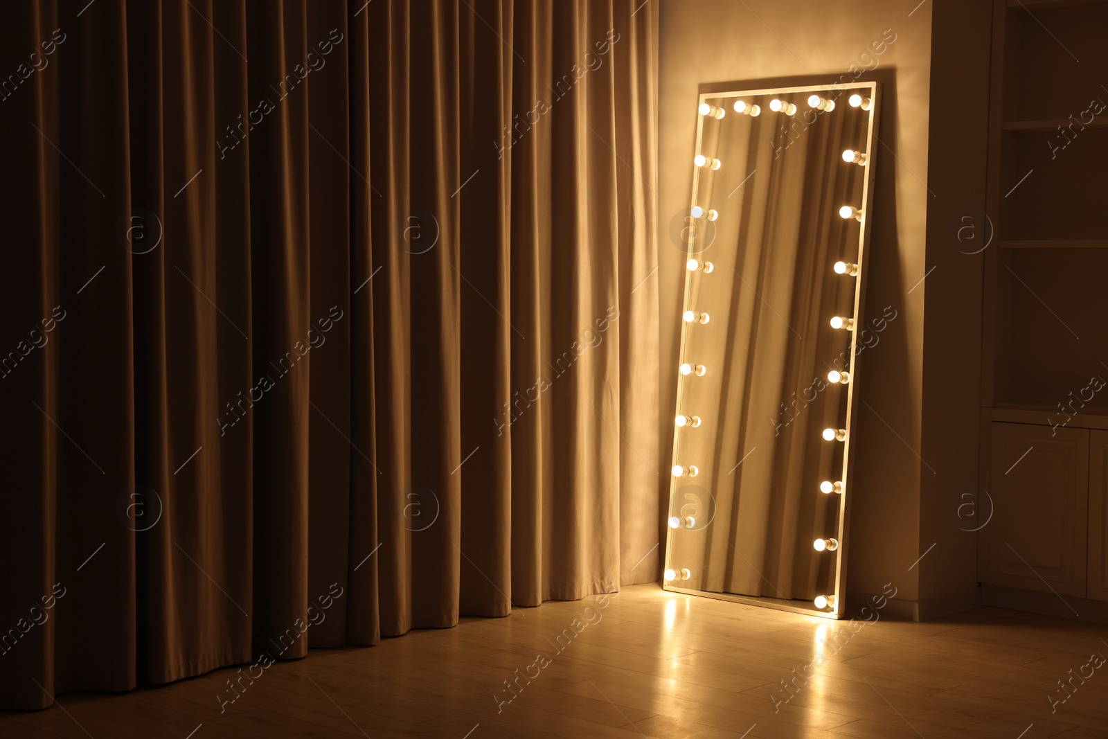 Photo of Modern mirror with light bulbs in makeup room